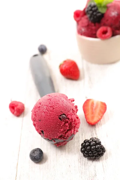 ice cream scoop in spoon with berry fruit