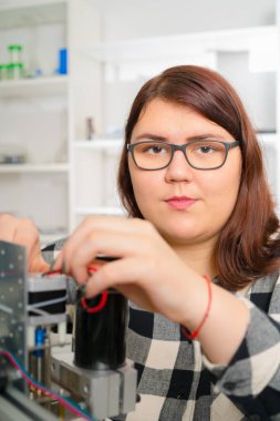 CNC makine üzerinde çalışan kadın çırak.