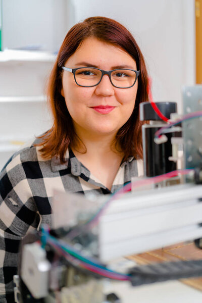 Female Apprentice working  on CNC machinery.