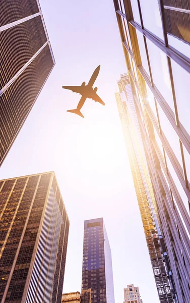 Plane over modern office buildings — Stock Photo, Image