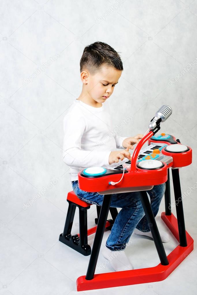 Boy plays on piano