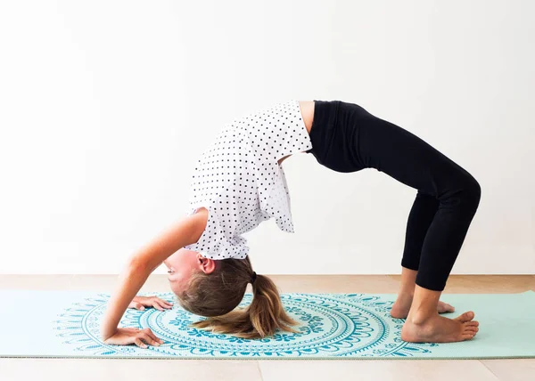 Liten flicka gör yoga övning — Stockfoto