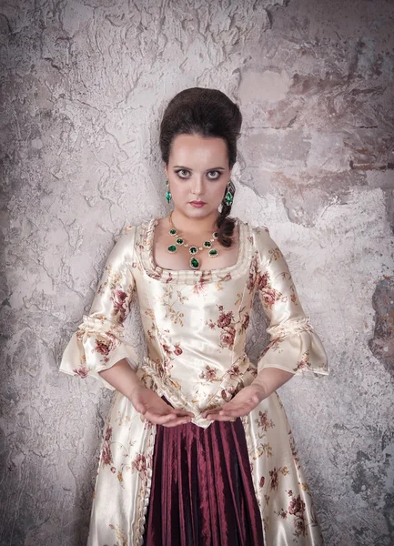 Beautiful woman in old medieval dress holding something in hands — Stock fotografie