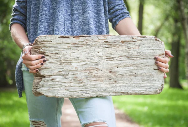 Woman holding empty wooden board. Template mock up — Stock Photo, Image