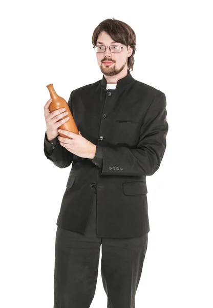 Junger Priester mit Flasche Alkohol isoliert — Stockfoto