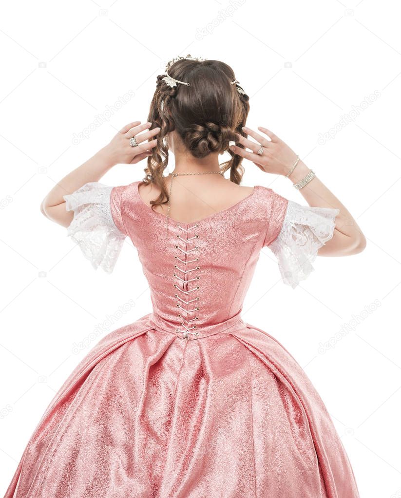 Beautiful woman in old historic medieval dress. Back pose 