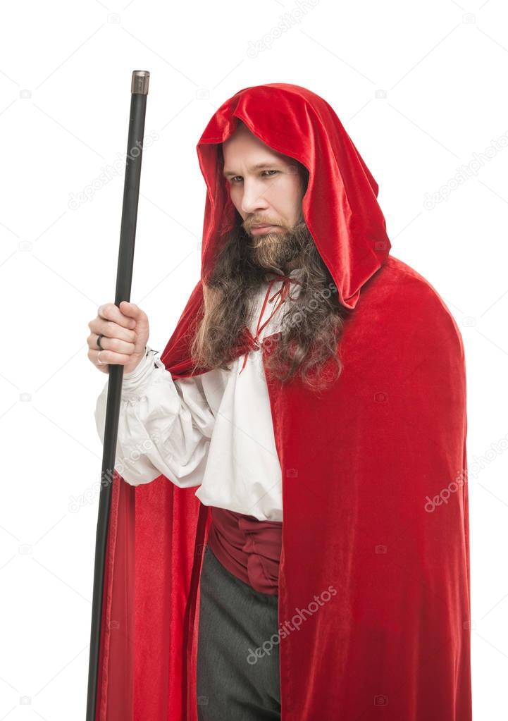 Medieval man in cape with cane isolated 