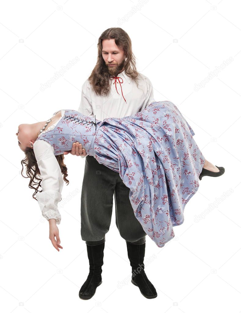 Handsome man in medieval costume holding beautiful woman on his 
