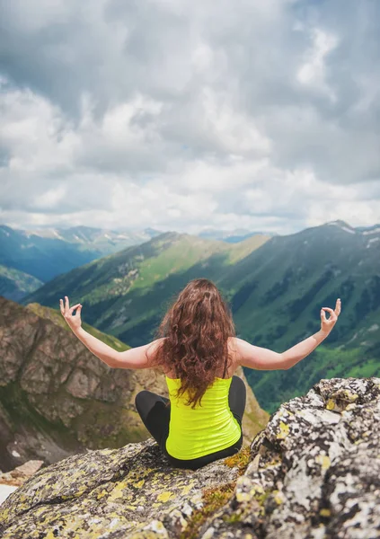 Frau macht Sport auf dem Gipfel des Berges — Stockfoto