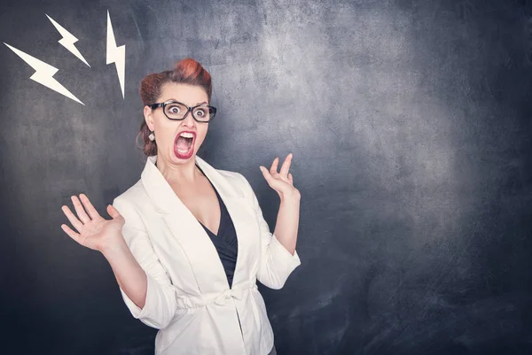 Angry screaming teacher on chalkboard background — Stock Photo, Image