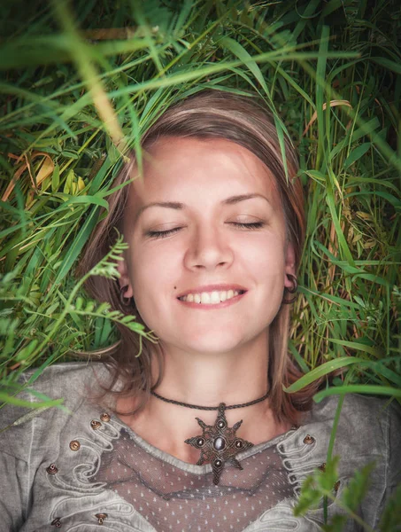 Счастливая красивая женщина лежит в траве — стоковое фото