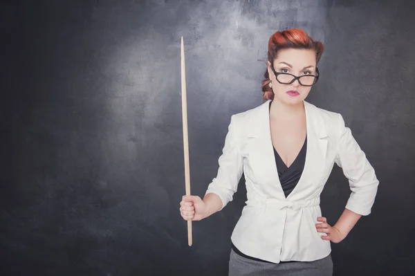 Serious teacher in glasses with pointer — Stock Photo, Image