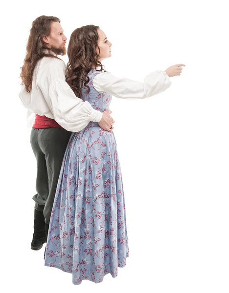 Beautiful couple woman and man in medieval clothes. Back pose