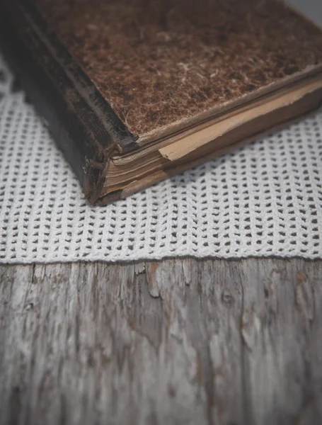 Vintage old book and lace fabric on the old wood — Stock Photo, Image