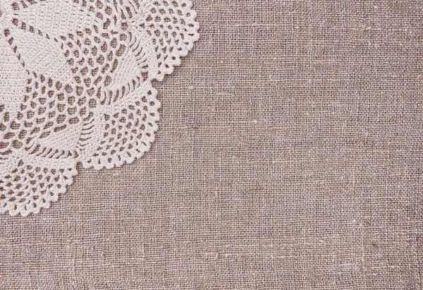 Vintage lace fabric border on the old burlap textile — Stock Photo, Image