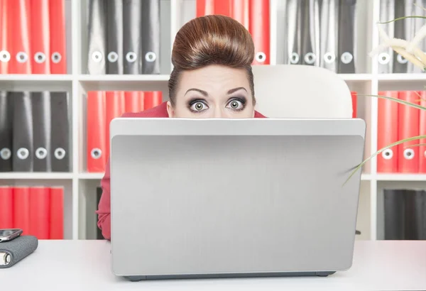 Business woman afraid and hiding behind the computer — Stock Photo, Image