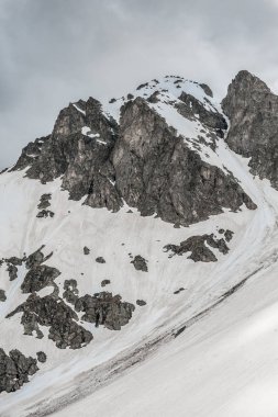 Kar ve gökyüzü ile kasvetli dağ manzarası 