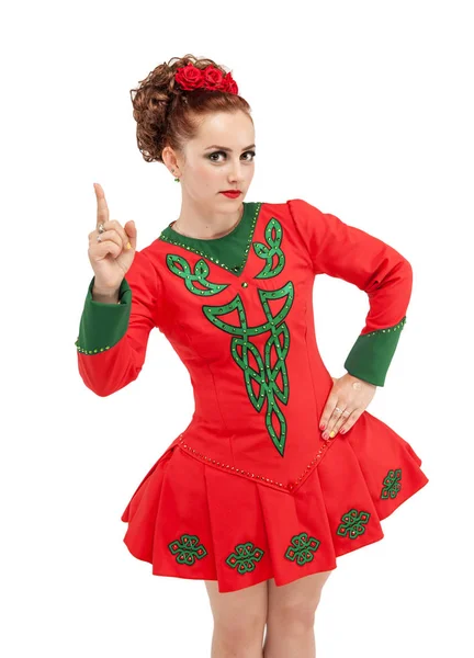 Beautiful woman in dress for Irish dance showing up by finger is — Stock Photo, Image
