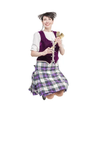 Young woman in clothing for Scottish dance jumping — Stock Photo, Image