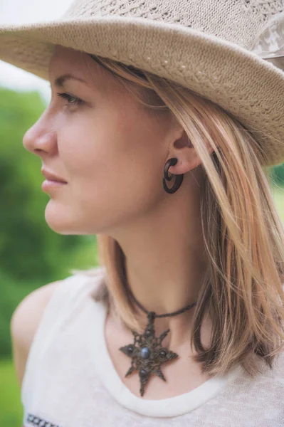 Beautiful woman portrait in hat with feather — Stock Photo, Image