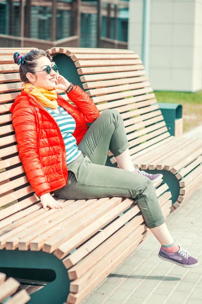 Fashion hipster woman with colorful hair sitting on the bench — Stock Photo, Image