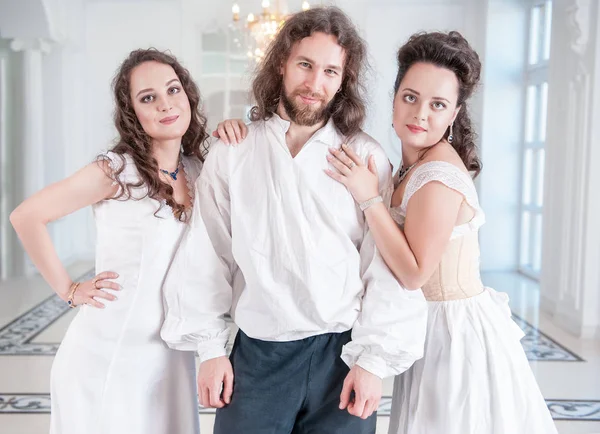 Handsome man in medieval costume and two woman in old-fashioned — Stock Photo, Image