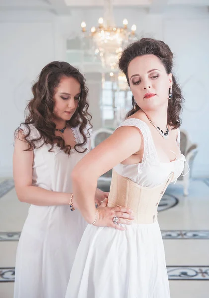 Two beautiful women in old-fashioned negligee