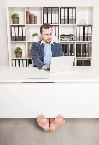Serious handsome barefoot business man in office — Stock Photo, Image