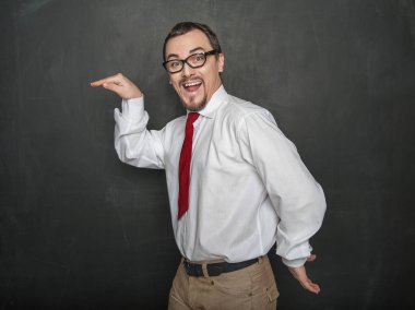 Funny handsome man dancing on chalkboard background