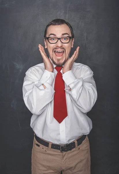 Surprised teacher or business man on blackboard background — 스톡 사진