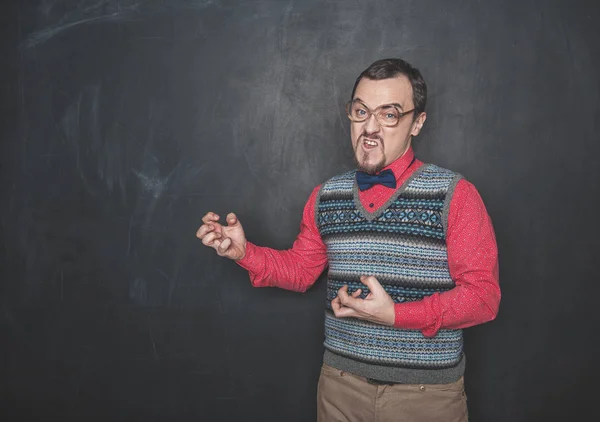 Angry teacher or business man on blackboard background — 스톡 사진