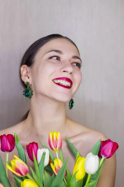 Beautiful young smile women with tulips