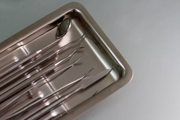 Metal dentist tools on a glass table — 스톡 사진