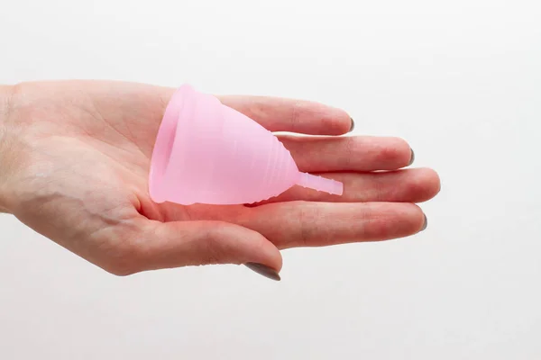 Menstrual cup in a female hand on a white background — Stock Photo, Image