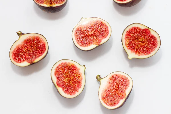 Halves of fresh figs on a white background with hard light — Stock Photo, Image