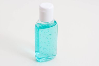 Beyaz arka planda antiseptik solüsyonu olan bir şişe. Kavanozda köpüklü mavi sıvı