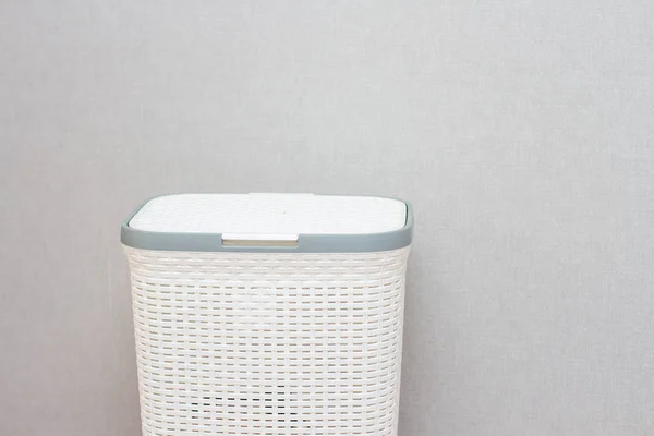 White laundry basket and clothes in a gray interior — Stock Photo, Image