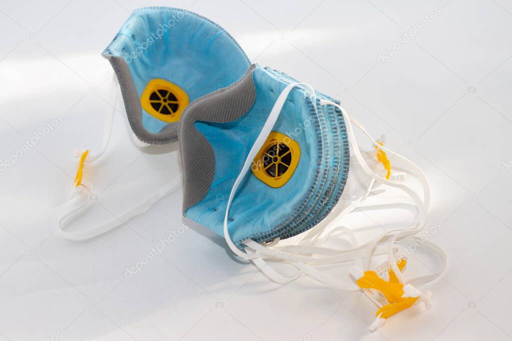 a two respirators for personal protection on a white background