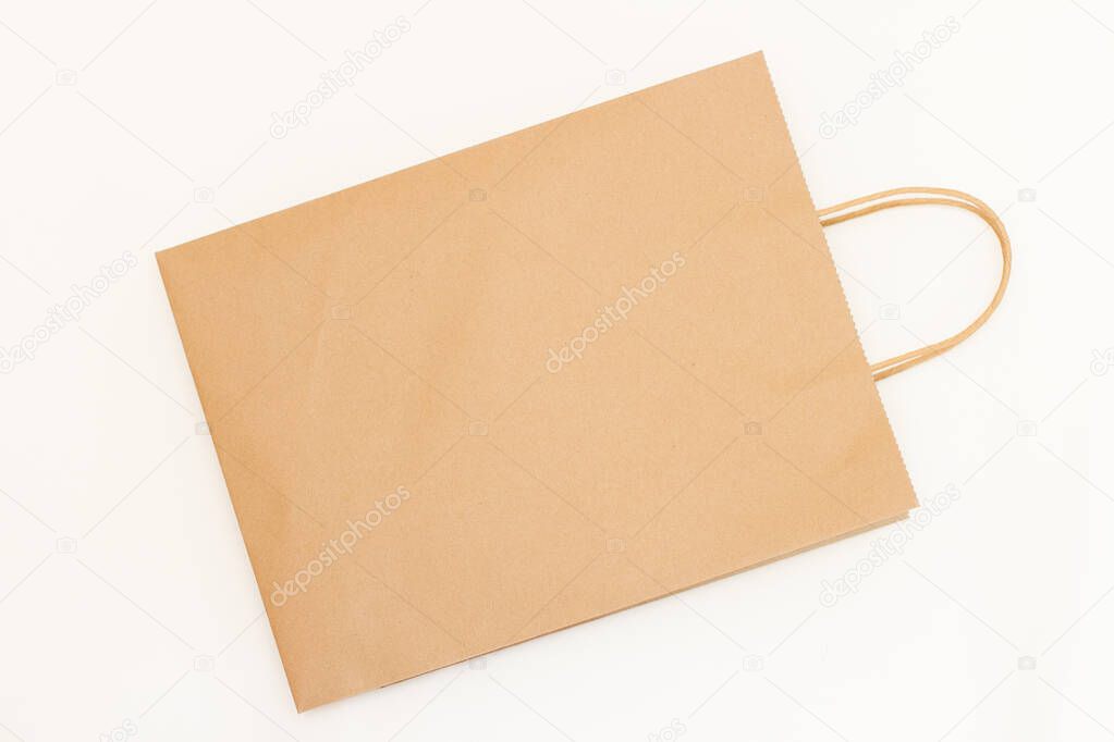 Top view brown paper shopping bag on white background. A empty craft paper bag.