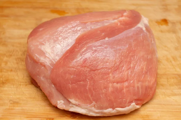生の豚ハム肉をナイフでまな板に乗せて — ストック写真
