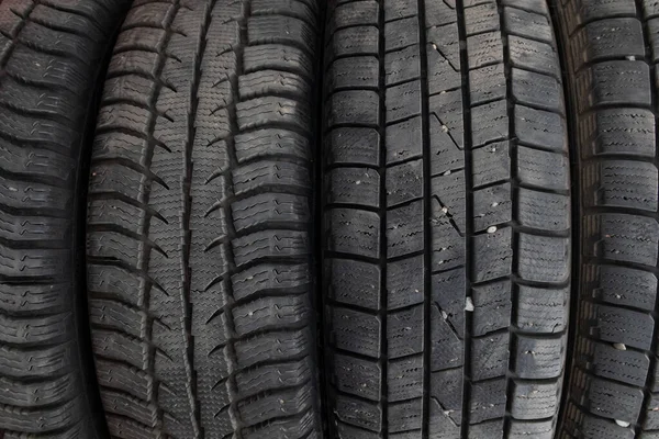 Tire stack background. Winter rubber vehicle tire.