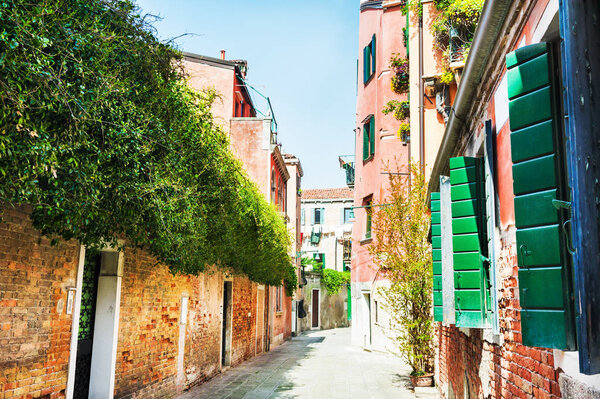 Beautiful street with colorful buildings in Venice, Italy