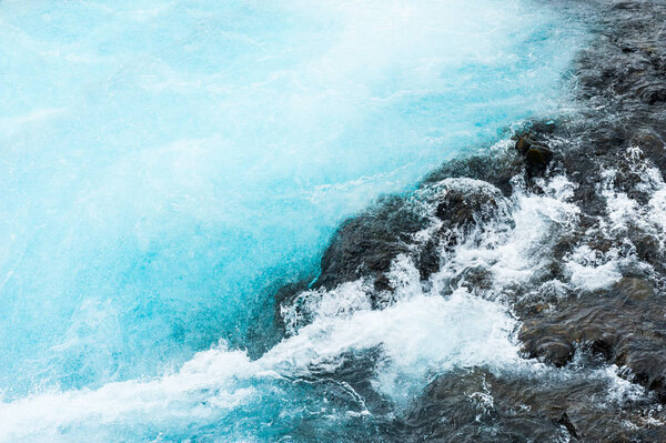 Blue water of Bruarfoss waterfall in Iceland.