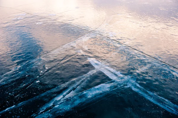 Ice on the frozen lake at sunset. — Stock Photo, Image