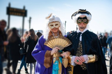 Venice, Italy - Februrary, 15, 2020: People wearing carnival masks at traditional Venice Carnival