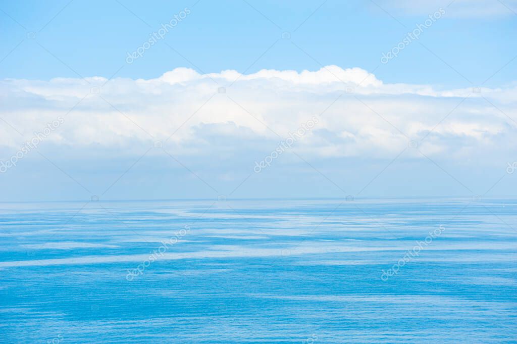 Blue sea background. Beautiful seascape and the blue sky with clouds. Travel destination concept