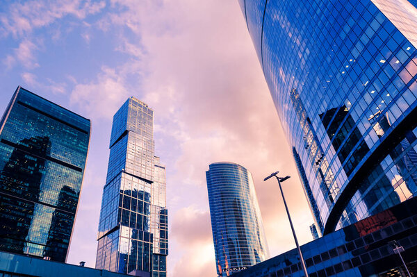 Modern glass skyscrapers against the sky at sunset. Bottom up view. Moscow, Russia