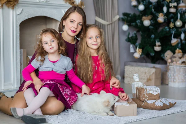 Happy kids with their mother near Xmas tree — Stock Photo, Image