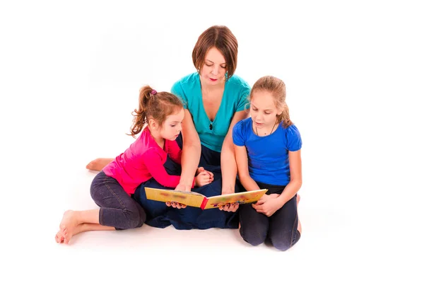 Mother reading a book to children isolated — Stock Photo, Image