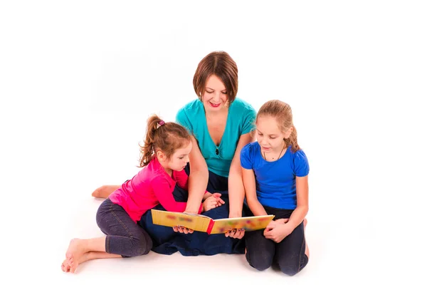 Mother reading a book to children isolated — Stock Photo, Image